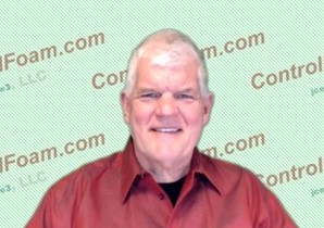 A man in red shirt smiling for the camera.